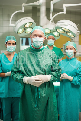 Smiling surgeon posing with a medical team
