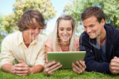 Three students using a tactile tablet