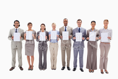 Business people holding white support for letters