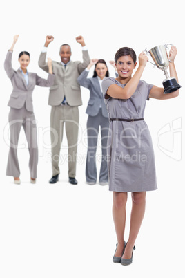 Woman holding a cup with happy co-workers