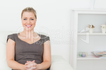 Woman sitting on a white sofa