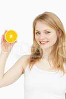 Smiling woman presenting an orange