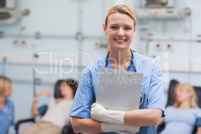 Smiling nurse holding a clipboard