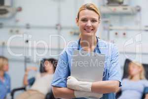 Smiling nurse holding a clipboard