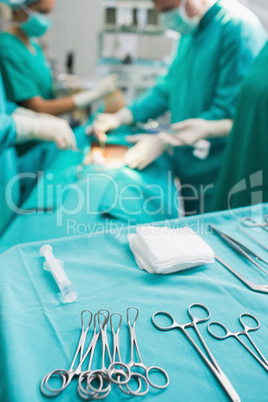 Focus on surgical tools next to operating table