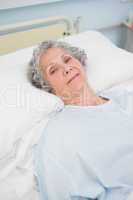 Patient looking at camera on a bed