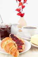 Table presentation with croissant spread with jam