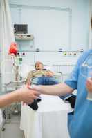 Nurse shaking hand of a transfused patient