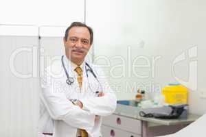 Doctor smiling while folding his arms