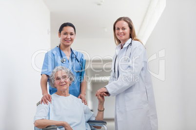 Patient in corridor holding hand of a doctor