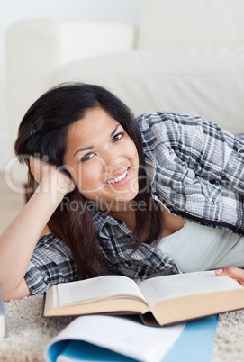 Close-up of a smiling woman holding a book