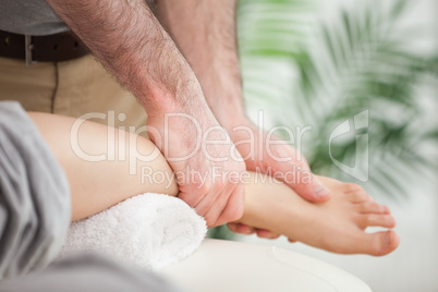 Close-up of a foot being massaged by a doctor