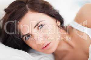 Serious brunette woman waking up