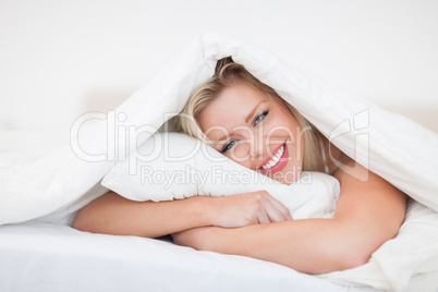 Blonde embracing her pillow