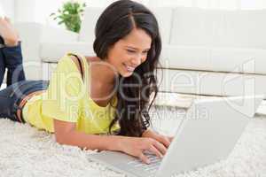 Beaming Latin woman using a laptop