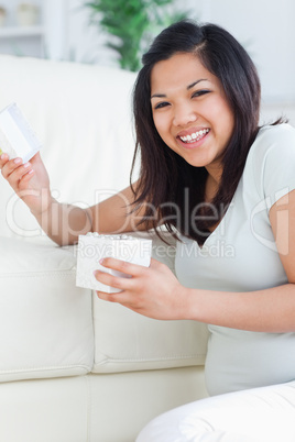 Woman smiling while holding an open gift box