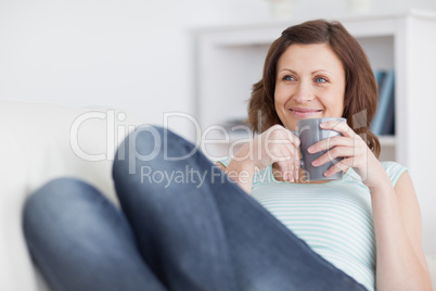 Woman smiling while holding a mug