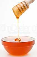 Honey trickle dropping in bowl