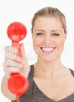 Woman smiling showing a retro phone