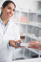 Pharmacist giving a drug box to someone