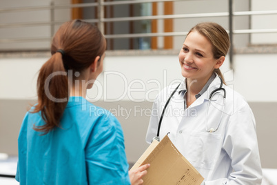 Woman doctor holding files and talking