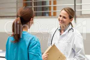 Woman doctor holding files and talking