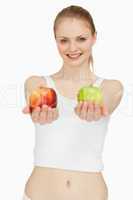 Joyful woman presenting two apples