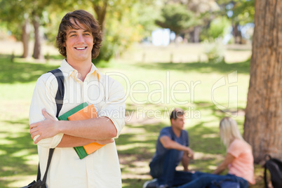 Young man posing with textbook