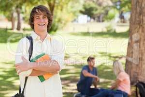 Young man posing with textbook