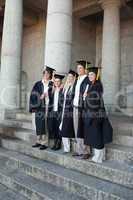 Graduates posing while smiling