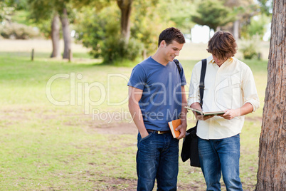 Two standing male students talking