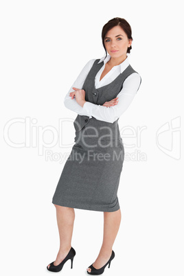 Seductive woman in suit posing with arms folded