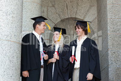 Happy graduates speaking together