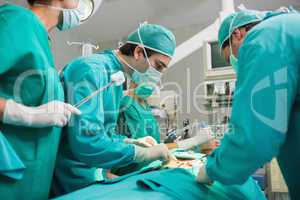 Surgical team looking at a patient