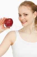 Woman holding an apple while smiling