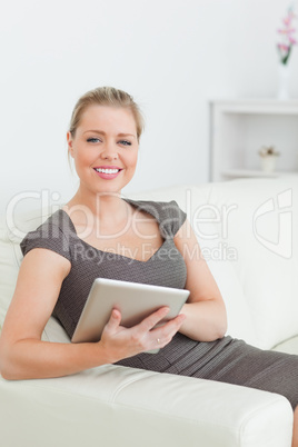 Woman smiling using a tablet pc