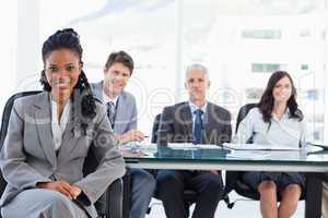 Young businesswoman sitting with her legs crossed and her hands