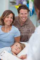 Parents and child looking at a doctor