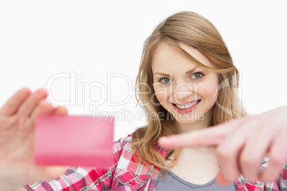 Woman holding a loyalty card while showing it