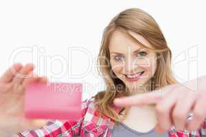 Woman holding a loyalty card while showing it