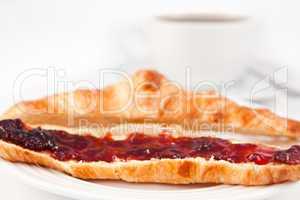 Croissant placed near a coffee cup