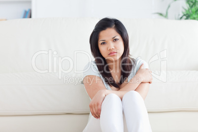 Woman sitting in front of a couch