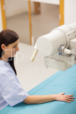 Woman positioning her arm on a medical table