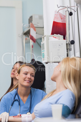 Smiling nurse looking at a female patient
