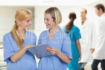 Smiling nurses holding a clipboard