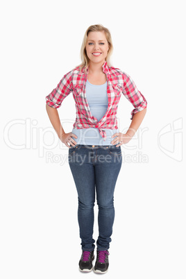 Happy young woman placing her hand on her hips