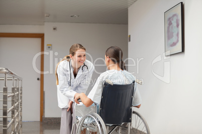 Patient sitting on a wheelchair in front of a doctor