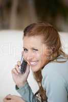 Woman smiling while phoning