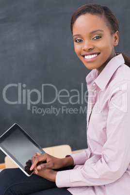 Teacher holding a tablet computer while smiling