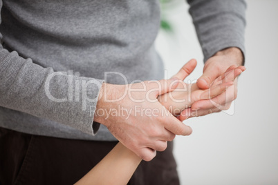 Masseur massaging the hand of  a woman